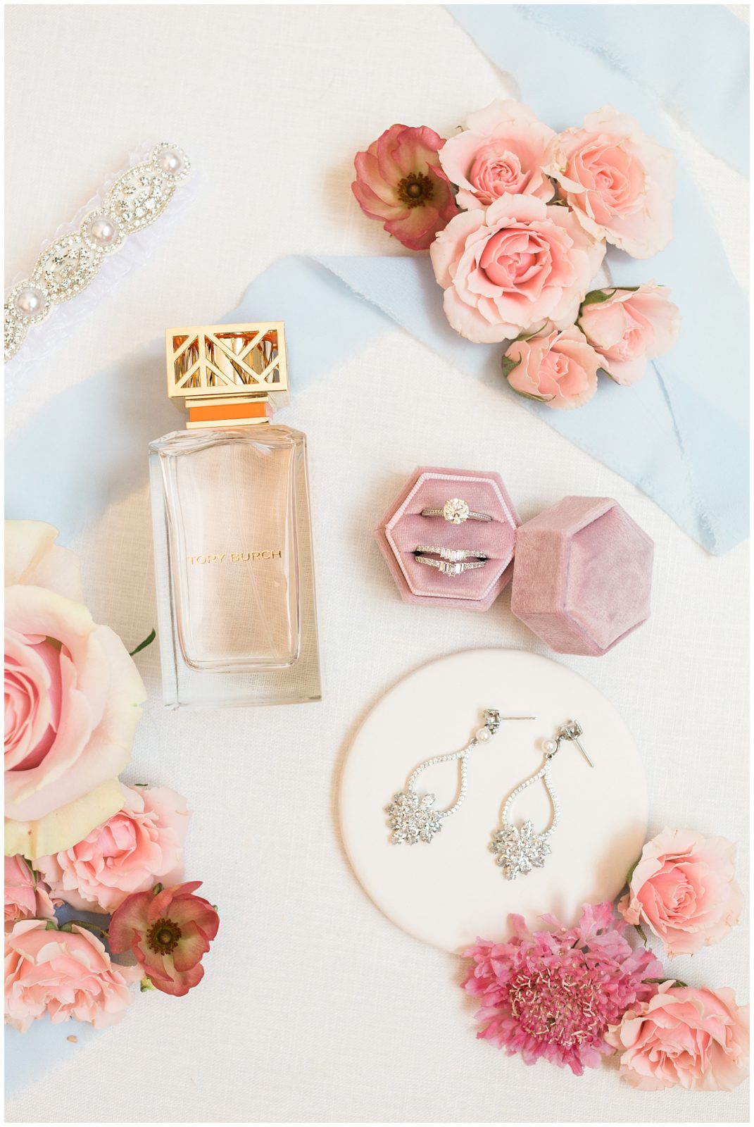 Jewelry and perfume flatlay on wedding morning