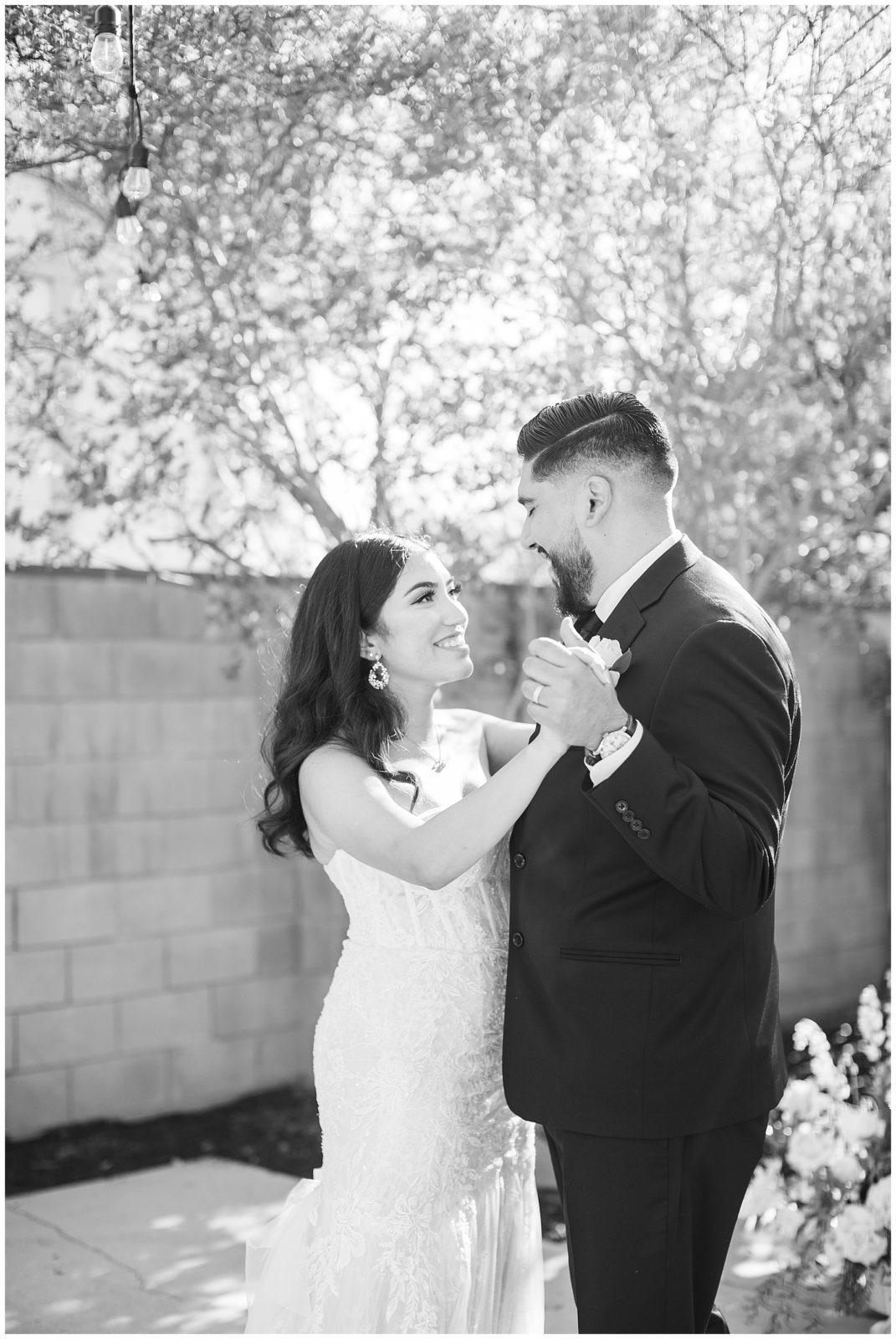 black and white image of first dance of couple for romantic backyard wedding