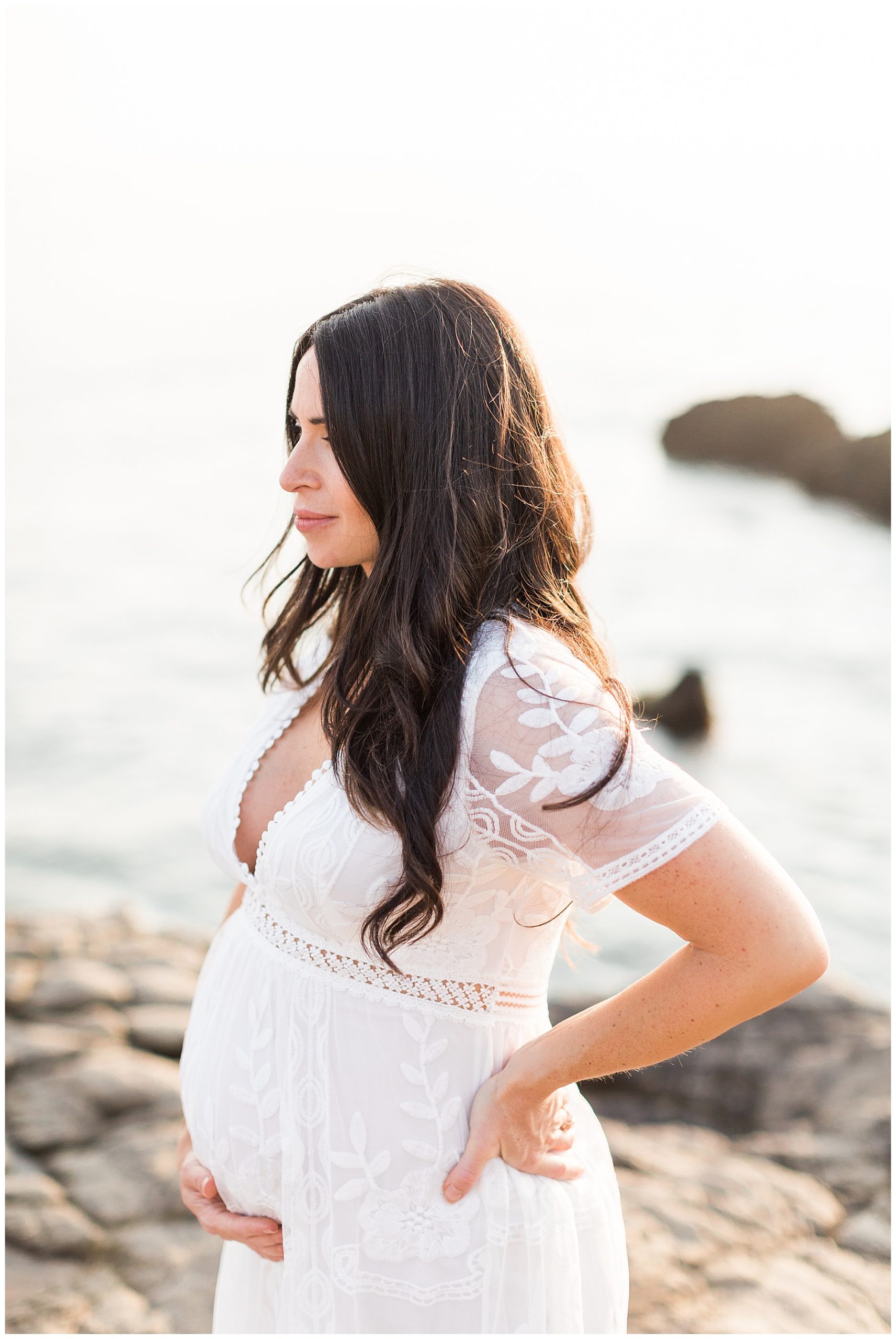 maternity photos with white dress on the beach