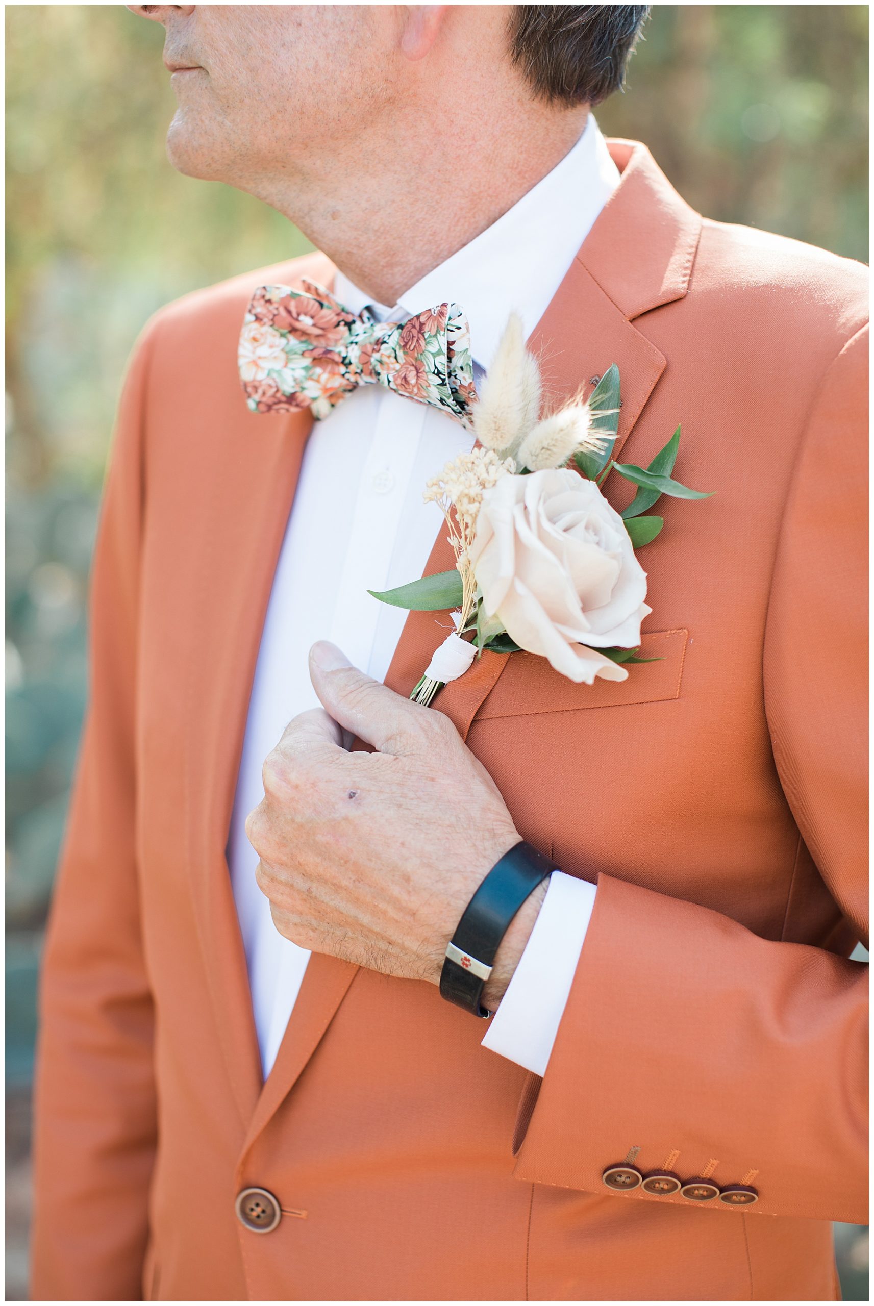 close up of groom's corsage
